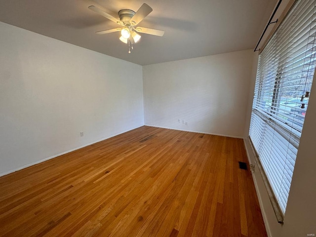 unfurnished room featuring hardwood / wood-style flooring and ceiling fan