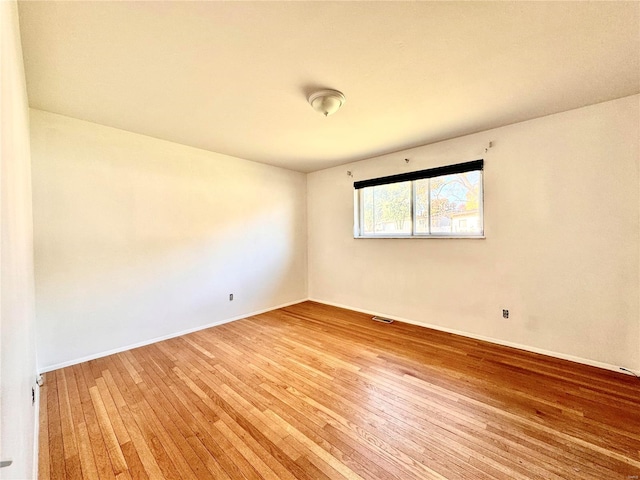 unfurnished room with hardwood / wood-style floors