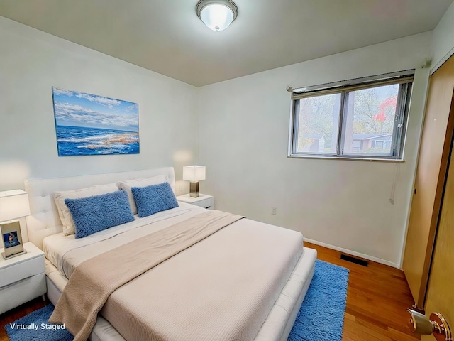 bedroom with hardwood / wood-style flooring