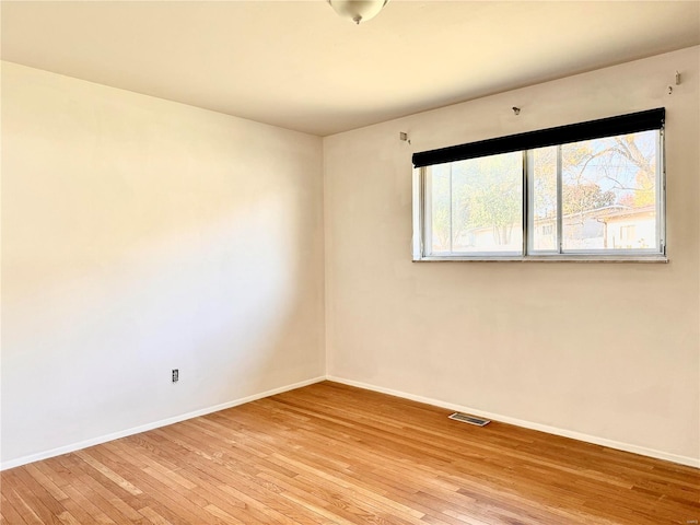 spare room with light hardwood / wood-style flooring