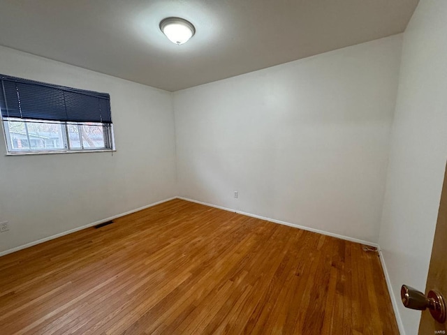 spare room with hardwood / wood-style flooring