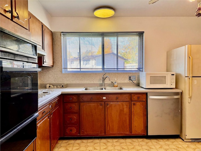 kitchen with decorative backsplash, sink, a healthy amount of sunlight, and white appliances