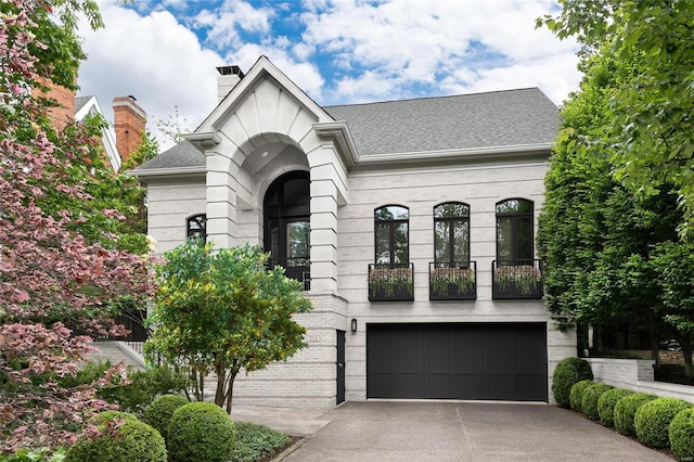 view of front of home featuring a balcony and a garage