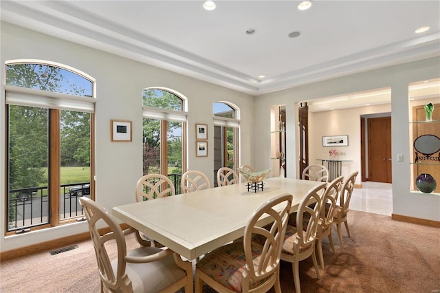 carpeted dining room with a wealth of natural light