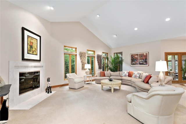 living room with high vaulted ceiling, a fireplace, and light carpet