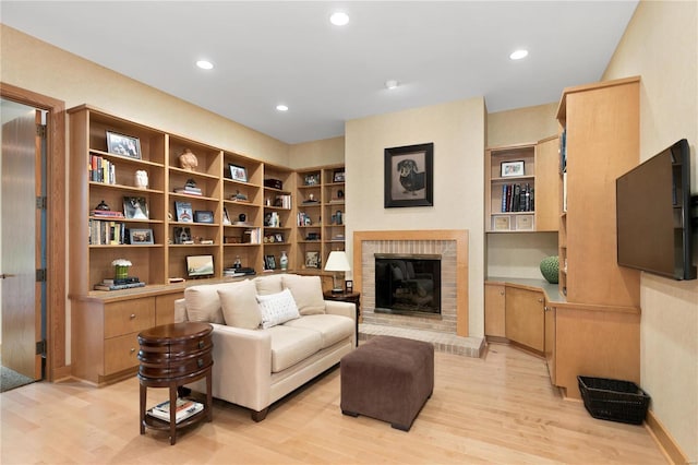 living area with a fireplace and light wood-type flooring