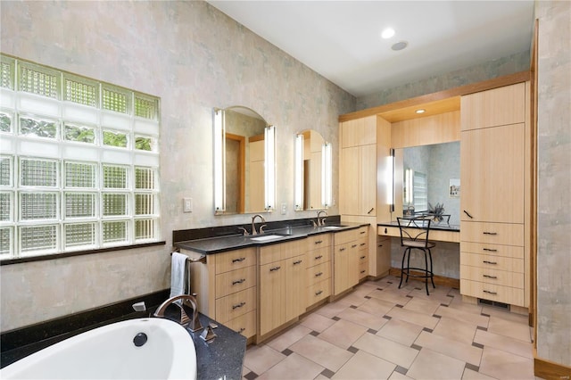 bathroom with vanity and a tub