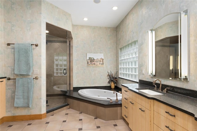 bathroom featuring tile patterned floors, vanity, and shower with separate bathtub