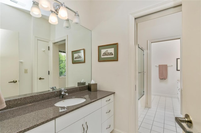 bathroom with shower / bath combination with glass door, vanity, and tile patterned flooring