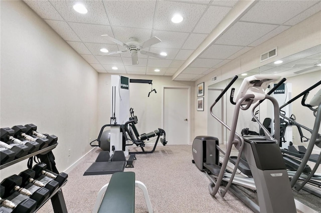 workout area with a paneled ceiling and ceiling fan