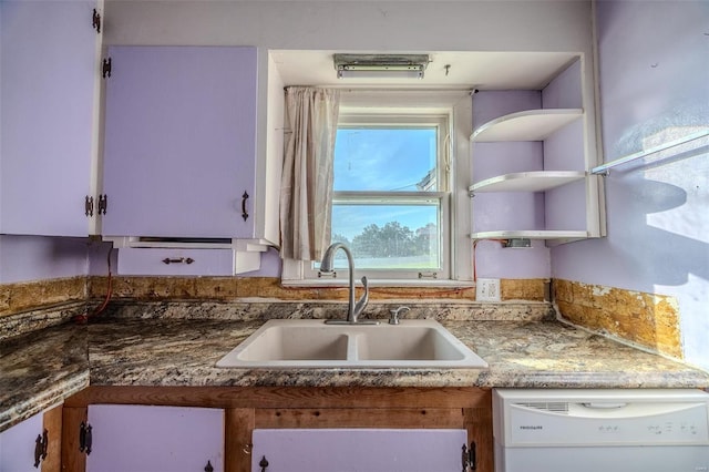 kitchen with white dishwasher, a sink, and open shelves