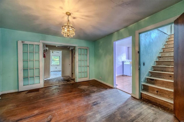 interior space featuring washer / clothes dryer, wood-type flooring, baseboards, and stairs