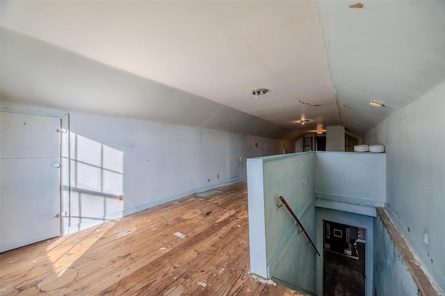 additional living space with lofted ceiling and wood-type flooring