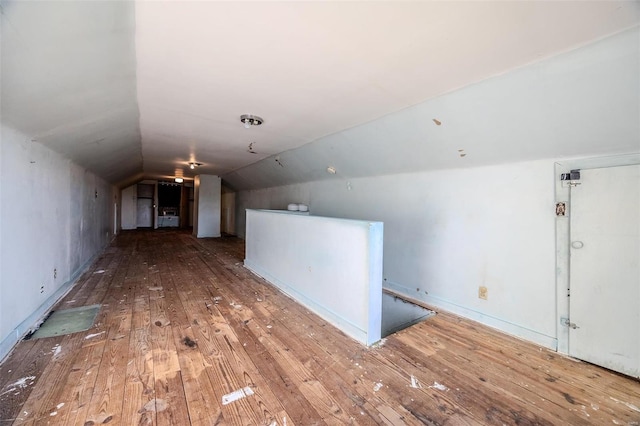 interior space featuring lofted ceiling and hardwood / wood-style floors