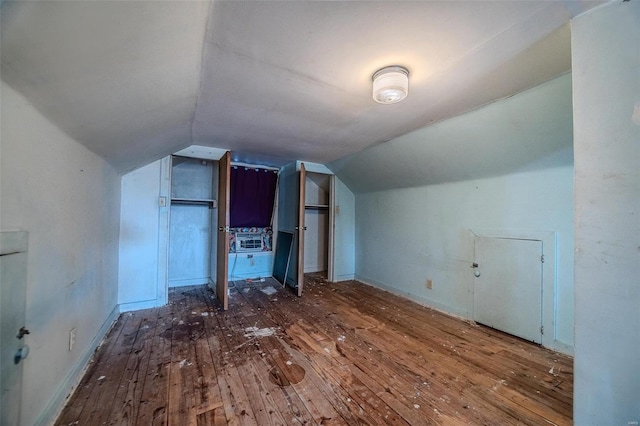 bonus room with cooling unit, vaulted ceiling, and hardwood / wood-style flooring