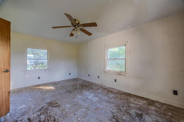 unfurnished room with ceiling fan and baseboards