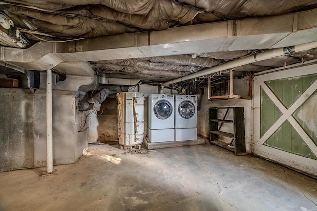 unfinished below grade area featuring washing machine and dryer and water heater