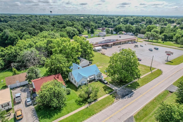 birds eye view of property featuring a wooded view