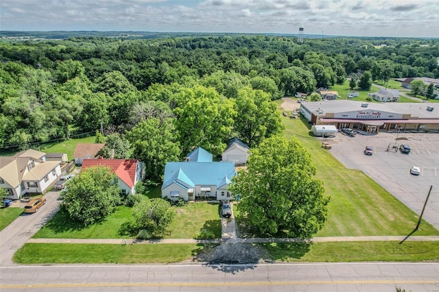 birds eye view of property with a view of trees