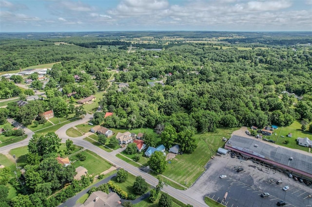 birds eye view of property with a wooded view