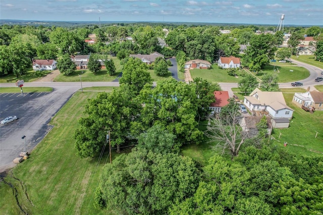 birds eye view of property featuring a residential view and a view of trees