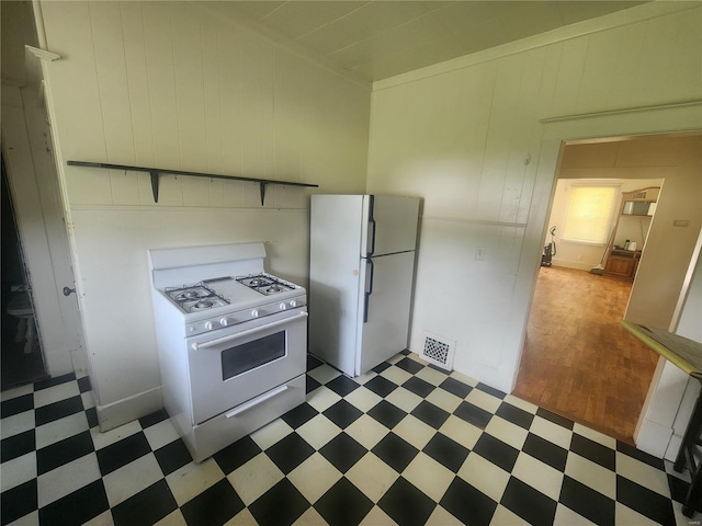 kitchen with dark hardwood / wood-style flooring and white appliances