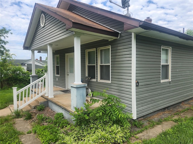 view of property exterior featuring covered porch