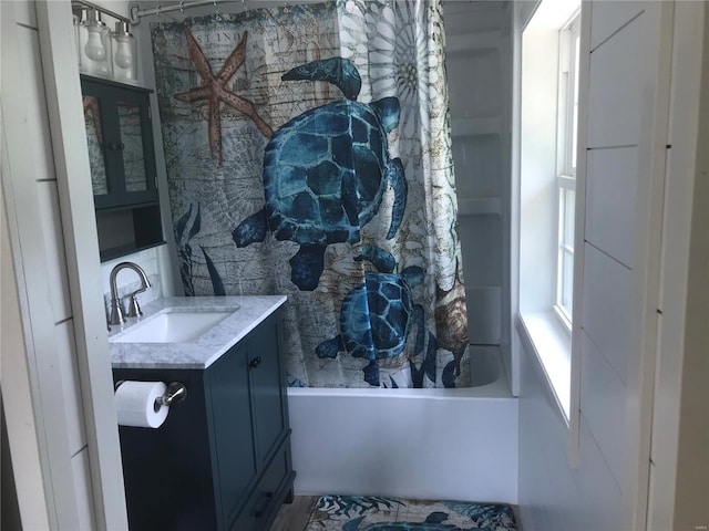 interior space with shower / bath combo with shower curtain and vanity