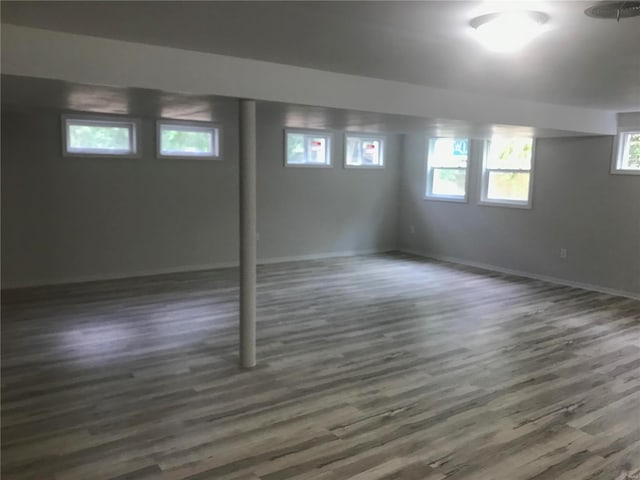 below grade area featuring dark wood-style floors and baseboards