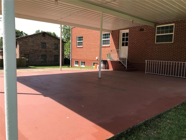 view of patio with entry steps and a carport