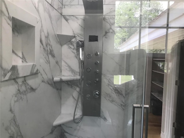 bathroom featuring marble finish floor and a marble finish shower