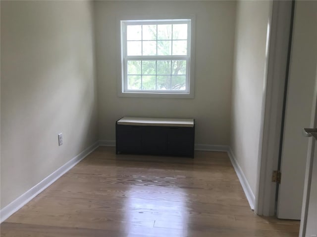 spare room featuring light wood-style flooring and baseboards