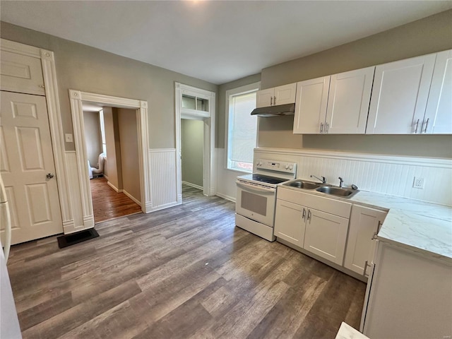 kitchen featuring hardwood / wood-style floors, white range with electric cooktop, white cabinets, sink, and light stone counters