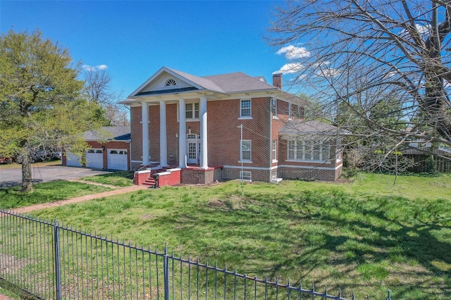 greek revival inspired property with a garage and a front lawn