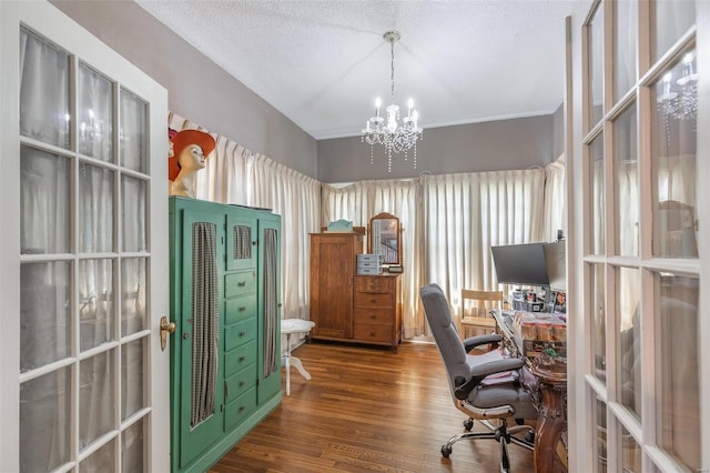 office space featuring a textured ceiling, dark wood-type flooring, and a notable chandelier