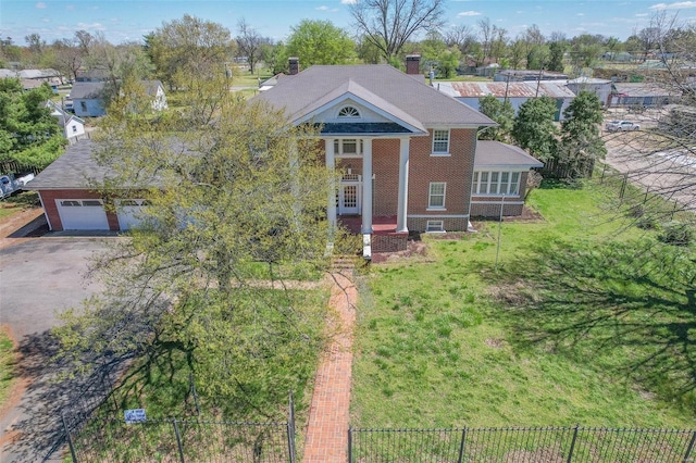 view of front of property with a garage and a front lawn