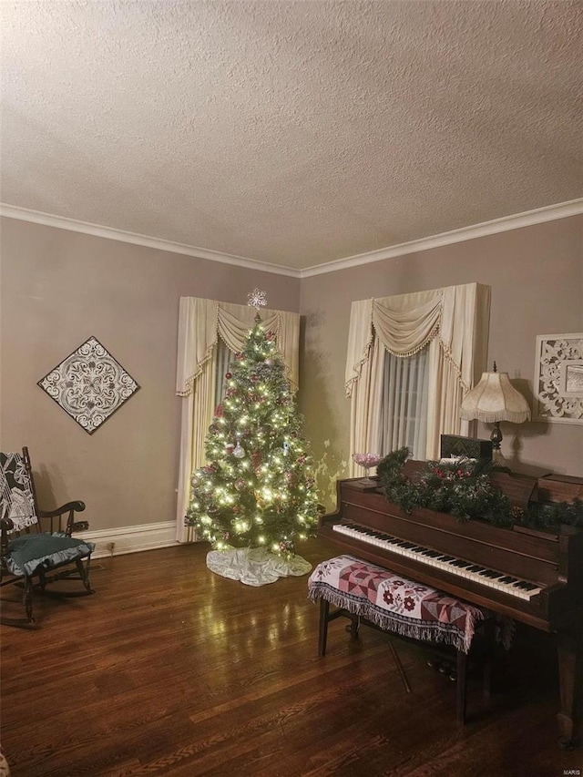 miscellaneous room featuring hardwood / wood-style flooring, crown molding, and a textured ceiling