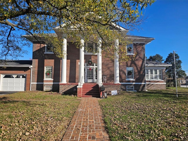 view of front of home with a garage and a front yard