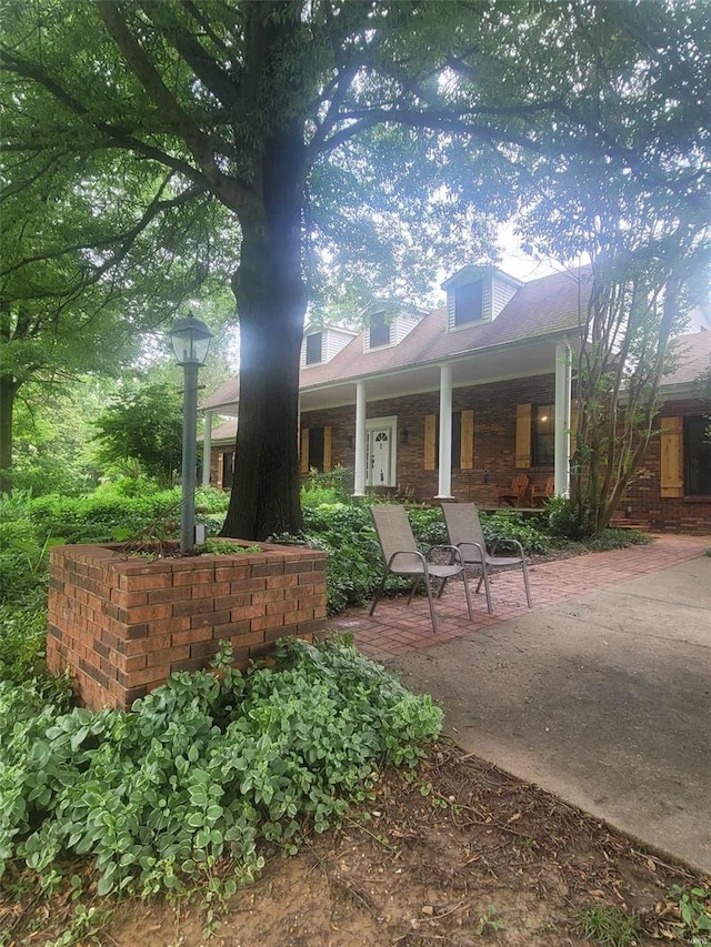 rear view of property featuring a porch