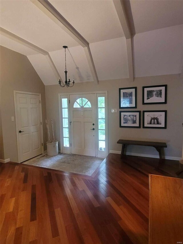 foyer with lofted ceiling with beams, wood-type flooring, and an inviting chandelier