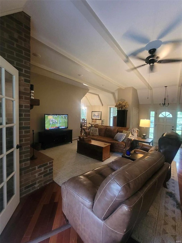 living room with brick wall, wood-type flooring, ceiling fan, and vaulted ceiling