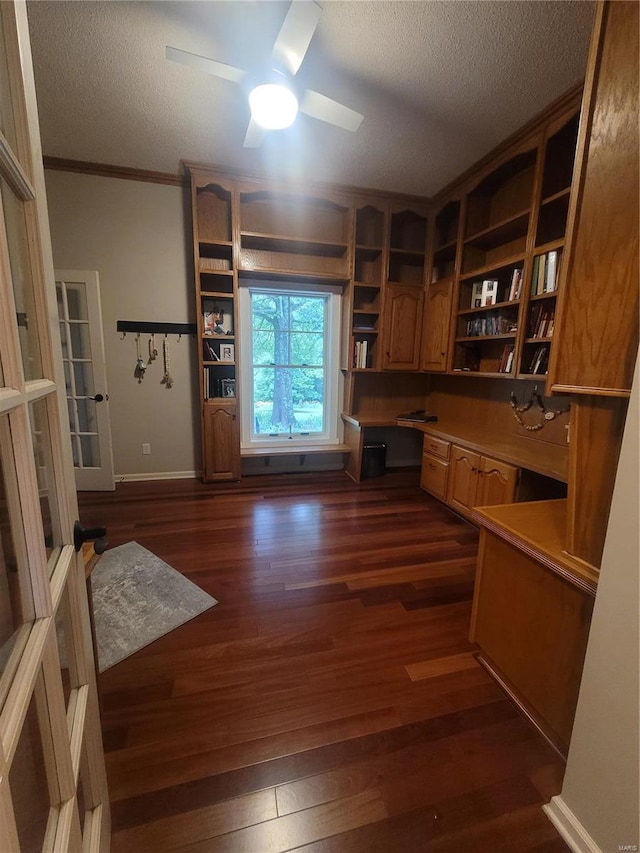 office area featuring crown molding, ceiling fan, a textured ceiling, and dark wood-type flooring