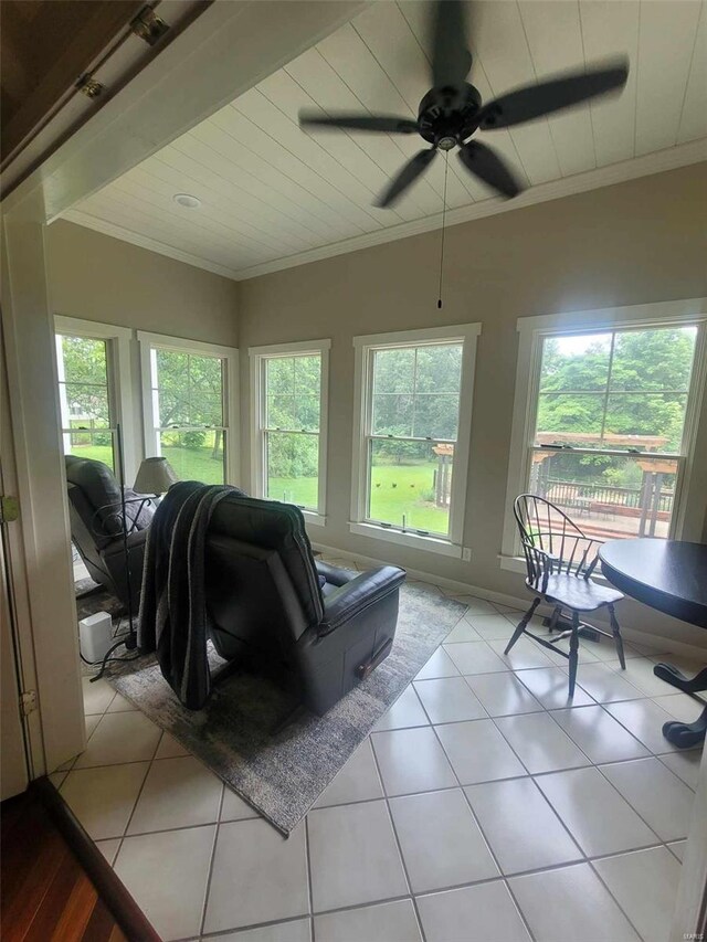 living room with tile floors, ceiling fan, and a wealth of natural light