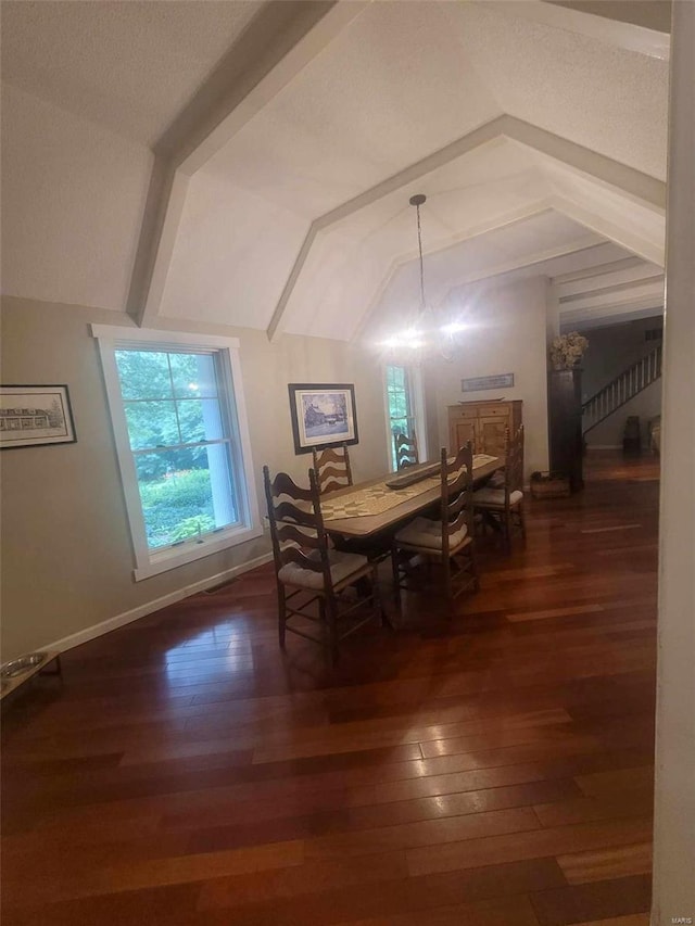 dining room featuring dark hardwood / wood-style floors and lofted ceiling with beams