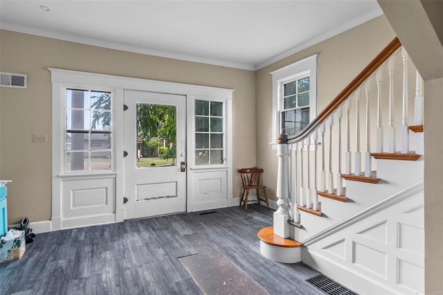 foyer entrance featuring dark hardwood / wood-style flooring and ornamental molding