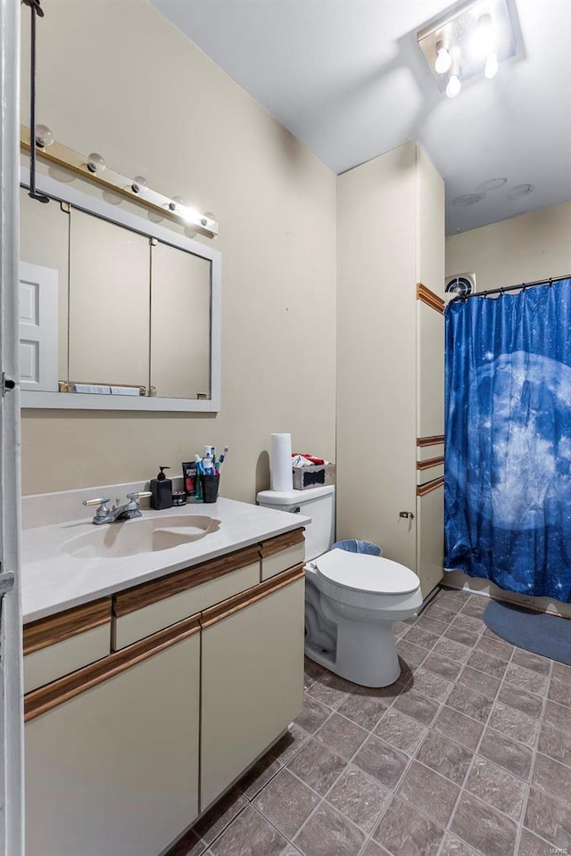 bathroom featuring toilet and vanity