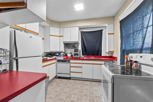 kitchen featuring white appliances and white cabinets