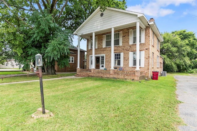 greek revival house featuring a front yard and central AC unit