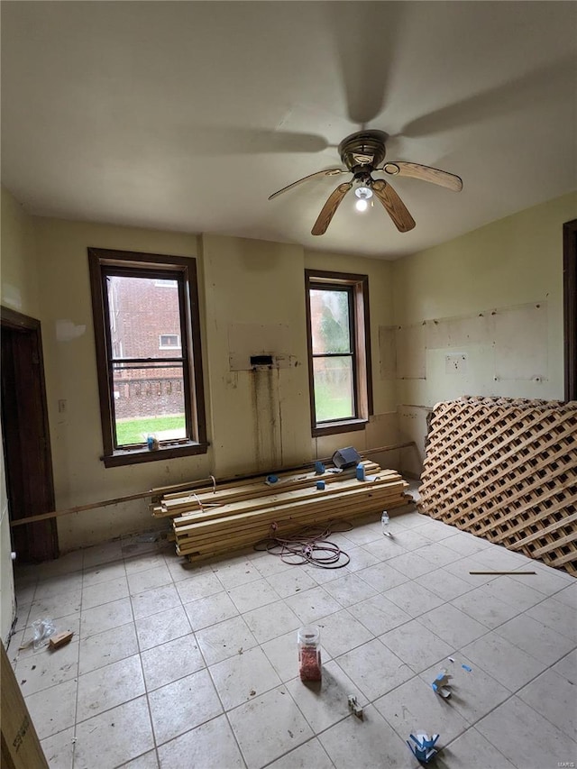 unfurnished room featuring ceiling fan and light tile patterned floors