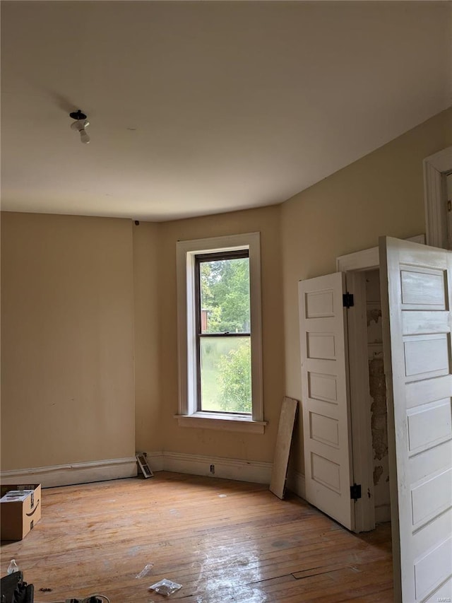 spare room with light hardwood / wood-style flooring